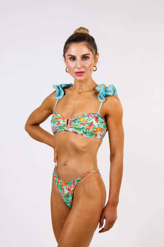 Model wearing the Bella Cheeky Bikini Bottom by Zinzina Swimwear, styled for luxury coastal escapes
