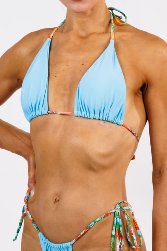 Model wearing the Graziella Triangle Bikini Top by Zinzina Swimwear, styled for luxury coastal escapes