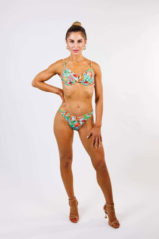 Model wearing the Marisa High Cut Bikini Bottom by Zinzina Swimwear, styled for luxury coastal escapes