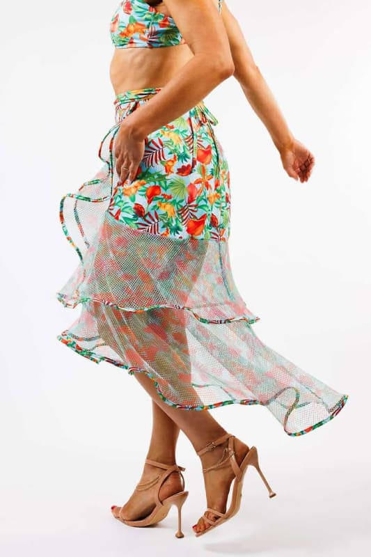The model is wearing the Sofia Wrap Skirt by Zinzina Swimwear, which is styled for luxury coastal escapes.
