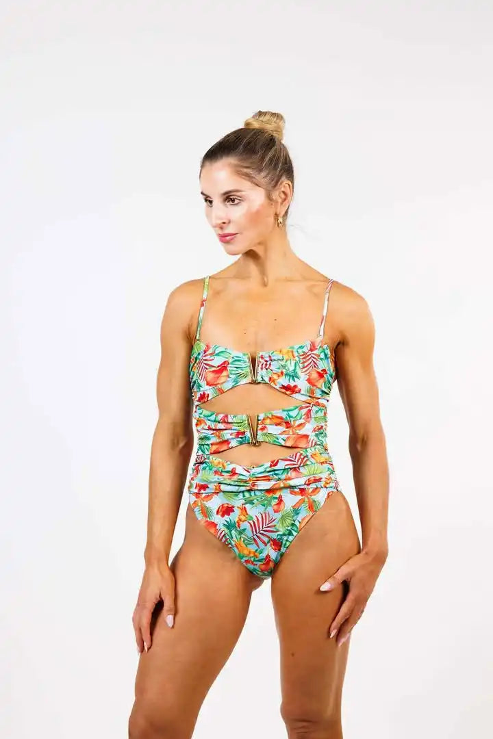 A tropical print one-piece swimsuit with cutouts and buckle details.
