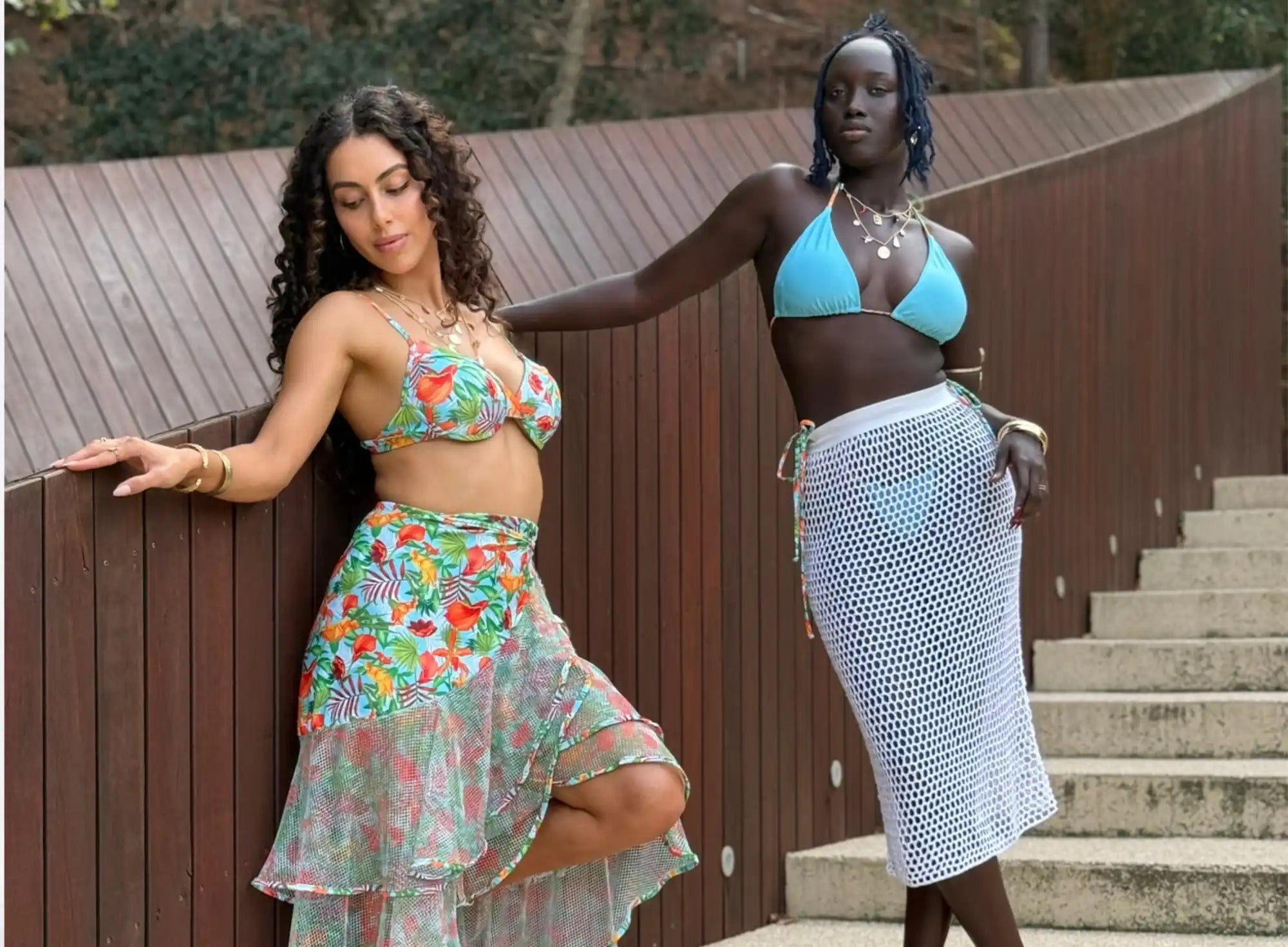 Two women modeling swimwear and beachwear.